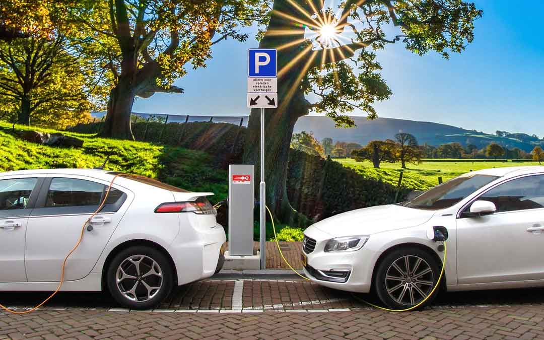 2 electric cars at a charging dock